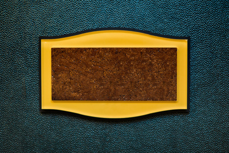 Retro cork blank sign board with yellow frame on blue textured backgroundの写真素材