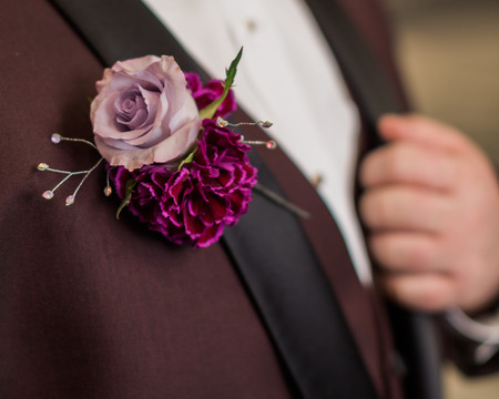 Detail of boutonniere. High school teen boy with pinned boutonniere on formal suit.の写真素材