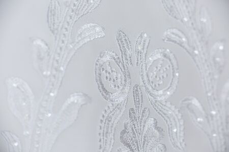 White floral lace embroidered texture textile macro close up backgroundの写真素材