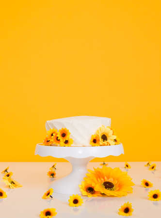 Cake smash setup with sunflower theme and bright vibrant yellow backgroundの写真素材