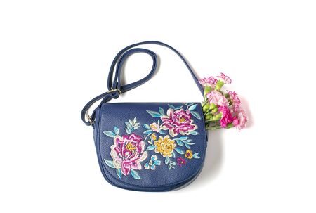 Bouquet of pink carnations flowers, womans handbag isolated on white background Holiday card Hello spring, seasonal, travel, creative concept. Flat lay Top view.の写真素材