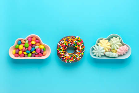 sweets - lollipop, meringues, macaroon in bowl in shape of cloud, chocolate, with colorful topping...