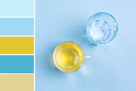 Pallete of colors Glass of water, cup of green tea on blue table Top view Flat lay Style life...