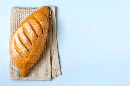 freshly baked sourdough bread on napkin from oven on blue wooden table Top view Flat lay Homemade pastry.の写真素材