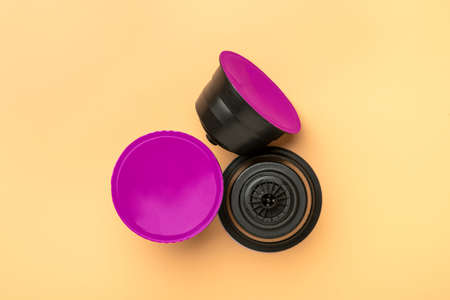 set of coffee capsules, roasted beans isolated on beige background Top view Flat lay Drink obtained from dosed capsule with roasted, ground and compressed natural coffee.の写真素材