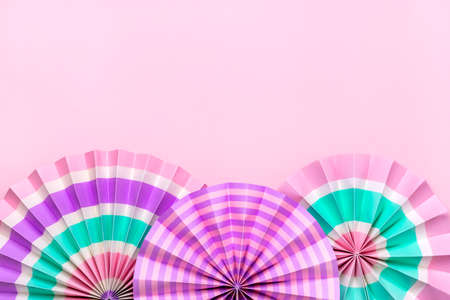 Traditional Japaneses festival paper fan with pink, turquoise, white stripes Birthday party,...