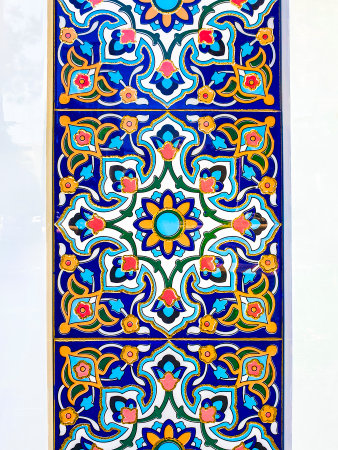 traditional Uzbek pattern on the ceramic tile on the wall of the mosque, abstract background.
