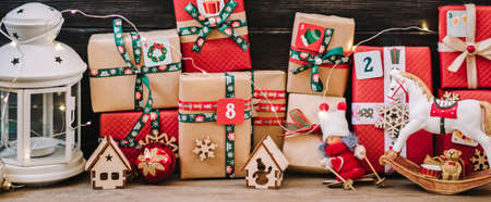 Handmade wrapped red, green gift boxes decorated with ribbons, snowflakes and numbers, Christmas...