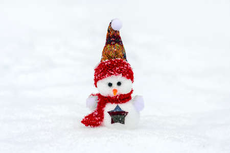 Merry christmas and happy new year greeting card with copy space Happy little snowman in red cap and scarf standing in winter snow background Xmas fairytale Hello January, February conceptの写真素材