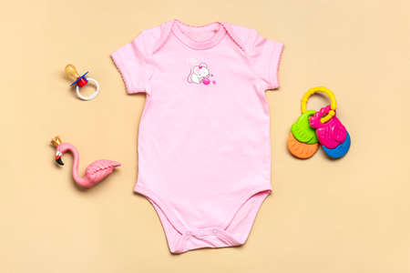 beautiful pink clothes for newborn girl, cotton fabric isolated on beige background Copy space Concept of childhood, motherhood, fashion textile and newborn Top view Flat lay.の写真素材