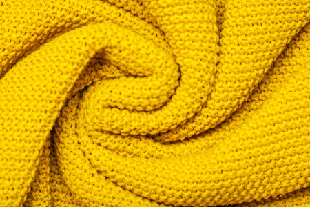 Bright yellow macro photo of textured jersey and knitting of sweater or sweatshirt. Pattern and background for fashion Warm Autumn concept.の写真素材