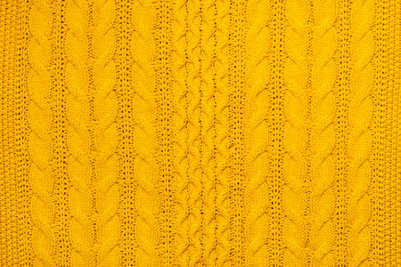 Bright yellow macro photo of textured jersey and knitting of sweater or sweatshirt. Pattern and background for fashion Warm Autumn concept.の写真素材