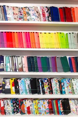 different multi-colored phone cases on store shelf.