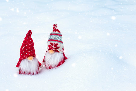 Christmas holiday card Cute scandinavian gnomes with red hat and white beard on snowy winter forest Fairytale snowfall Wintertime Hello December, January, February concept Happy New Year, Christmas.の写真素材