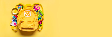 Back to school, education concept Yellow backpack with school supplies - notebook, pens, eraser...