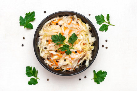 sour cabbage in wooden bowl pepper on white table Fermented vegetable concept Healthy food Top view.の写真素材