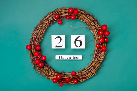 Christmas wreath and wooden calendar with date December 26 on red background Boxing Day occurs annually on December 26の写真素材