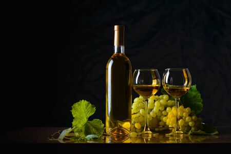 The composition of bottle 2 glass of white wine and fresh grapesの写真素材