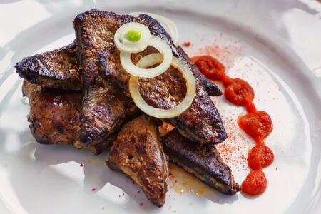 Fried liver with onion and tomato ketchup seasoned with spicesの写真素材