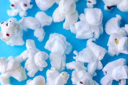 Popcorn on a blue background. Macro image of popcorn.の写真素材