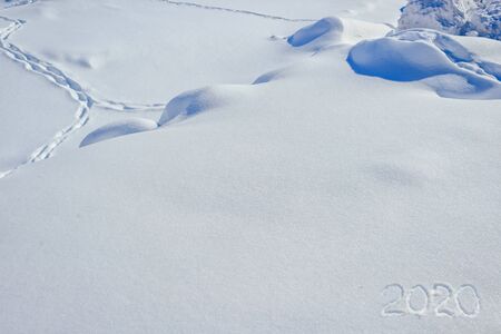 Handwritten inscription on snow 2020. Happy New Year.