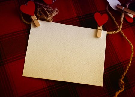 Valentines day photo frame or greeting card and handmade hearts, clothespins hearts on ropeの写真素材