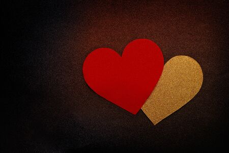 Love hearts on black background. Valentine's day card concept. Gold and red heart on black backgroundの写真素材