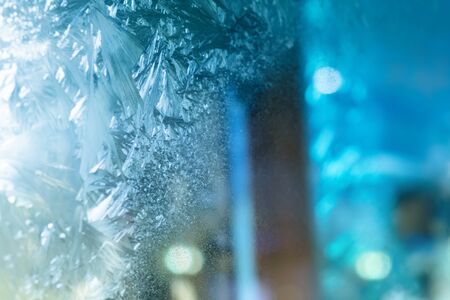 Natural Ice, Cool Winter Abstract Ice Glass, Frost background. Ice patterns on glass. Beautiful Christmas and New year Christmas art design, abstract blue background with ice pattern.の写真素材