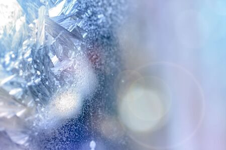 Natural Ice, Cool Winter Abstract Ice Glass, Frost background. Ice patterns on glass. Beautiful Christmas and New year Christmas art design, abstract blue background with ice pattern.の写真素材