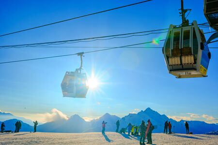 Russia, Glade Azau, Elbrus-January 20, 2019: skiers and snowboarders relax and take a selfie on the background of snow-capped mountains. Cable car on the ski slope in the glade Azau.のeditorial素材