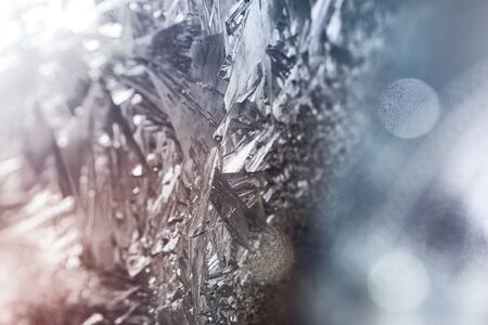 Natural Ice, Cool Winter Abstract Ice Glass, Frost background. Ice patterns on glass. Beautiful Christmas and New year Christmas art design, abstract blue background with ice pattern.の写真素材