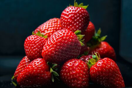 Strawberry closeup. Macro image of fresh strawberries on dark background.の写真素材