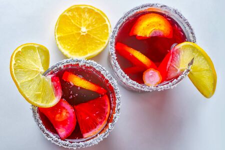 Punch drink sangria with fruit on a light background decorated with coconut shavingsの写真素材