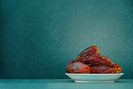 The Concept Of Ramadan. Dates on a green background. Place for text.の写真素材