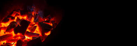 Grill with hot coals and beautiful magic sparks with a blue flameの写真素材