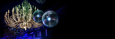 A large antique chandelier. Neon lights illuminate the interior of the nightclub