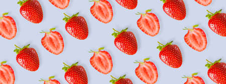 Beautiful pattern of fresh red strawberries on a colored background.