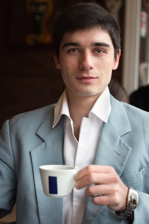 The man with a cup of coffee in cafeの写真素材