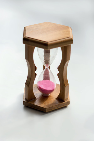 Beautiful old fashioned sand glasses in wooden frame