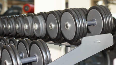 Row of barbells or dumbbells in the gym