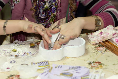 Female hand with paper preparation for a decoupageの写真素材