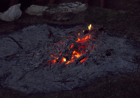 Campfire from firewood and ashes outdoors