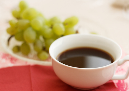 cup of natural coffee with grapes for breakfastの写真素材
