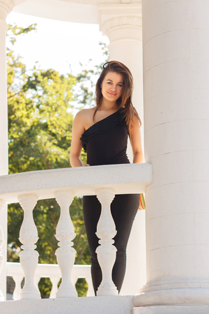 positive young tourist girl in casual clothes walking in the parkの写真素材