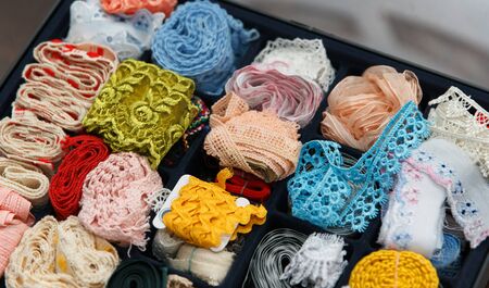 The box is filled with multicolored tapes for handmade and embroideryの写真素材