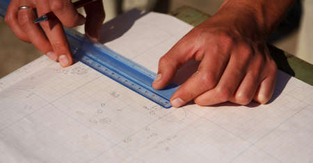 Archaeologist designs, draws with pencil on paper a drawing of ancient archaeological artifacts...