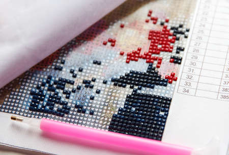 Process of creation of diamond painting 3d from square rhinestones, handmade hobby for restの写真素材