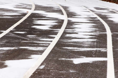 New treadmill, paved, with markings for runner athletes. In winter in snowy weatherの写真素材
