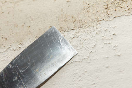 Repair, there is a construction professional process of patching the wall with a spatula