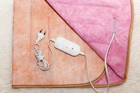 Surface of a warm two-sided electro sheet, laid out on the bed, looks from the top. This is a quick and economical way to heat up in the cold season, in winterの写真素材